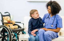 A child with special needs due to chromosome 8P inversion duplication syndrome with a doctor.